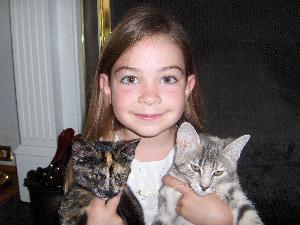 Child with 2 cats